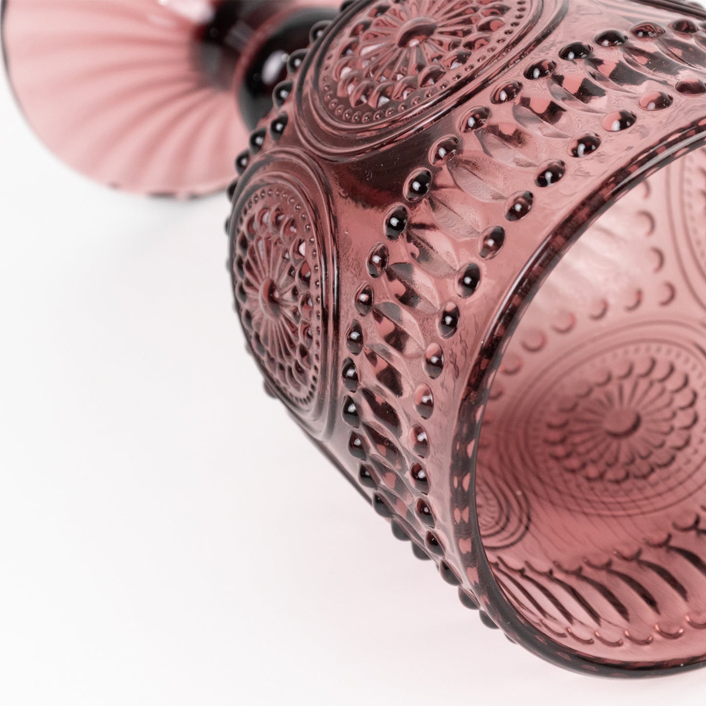 Dusty rose vintage embossed goblet wine glass with floral pattern.