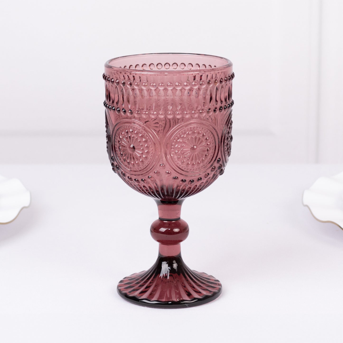 Dusty rose vintage embossed goblet wine glass with floral pattern.