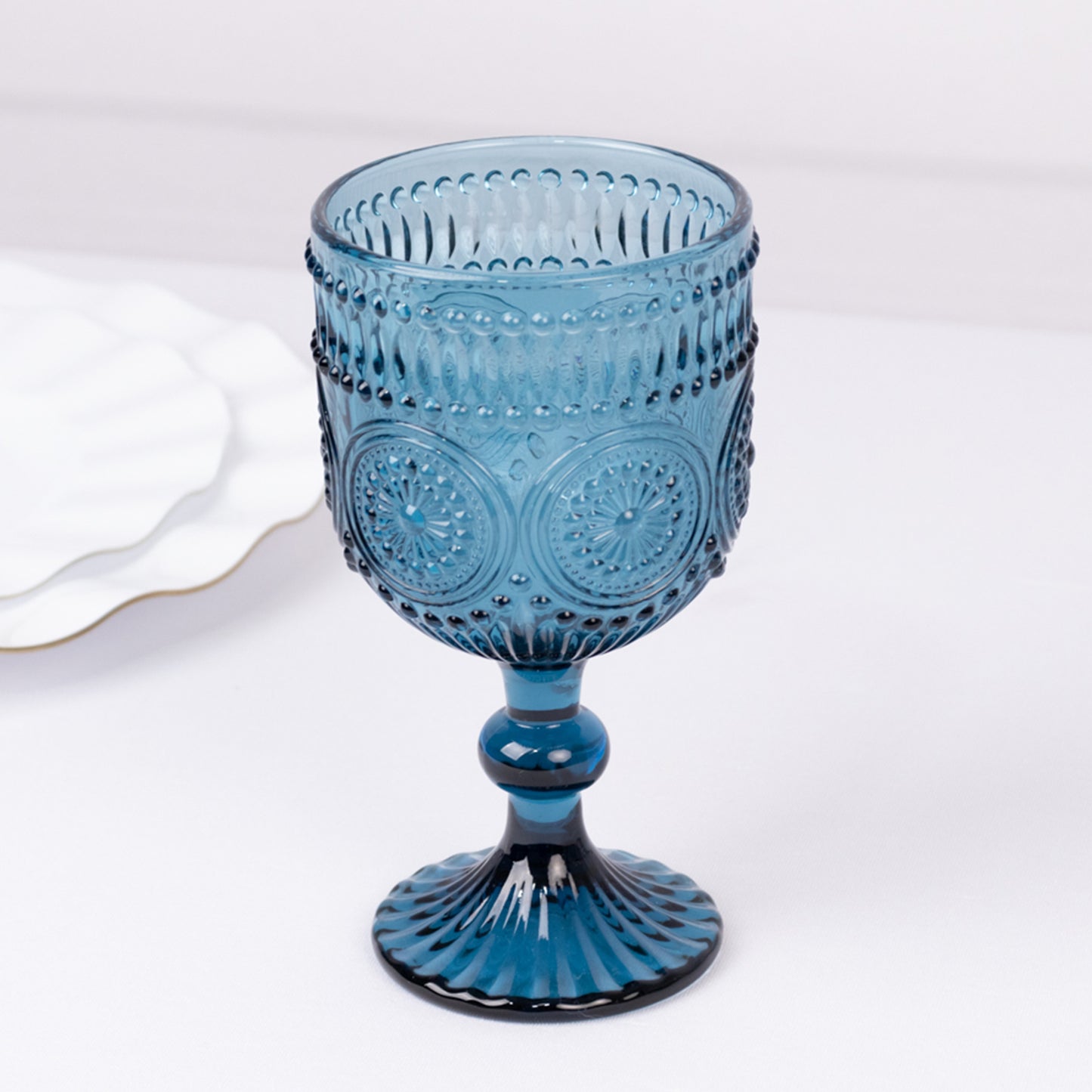 Ocean blue vintage embossed goblet wine glass with textured floral pattern.
