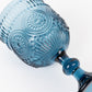 Ocean blue vintage embossed goblet wine glass with textured floral pattern.
