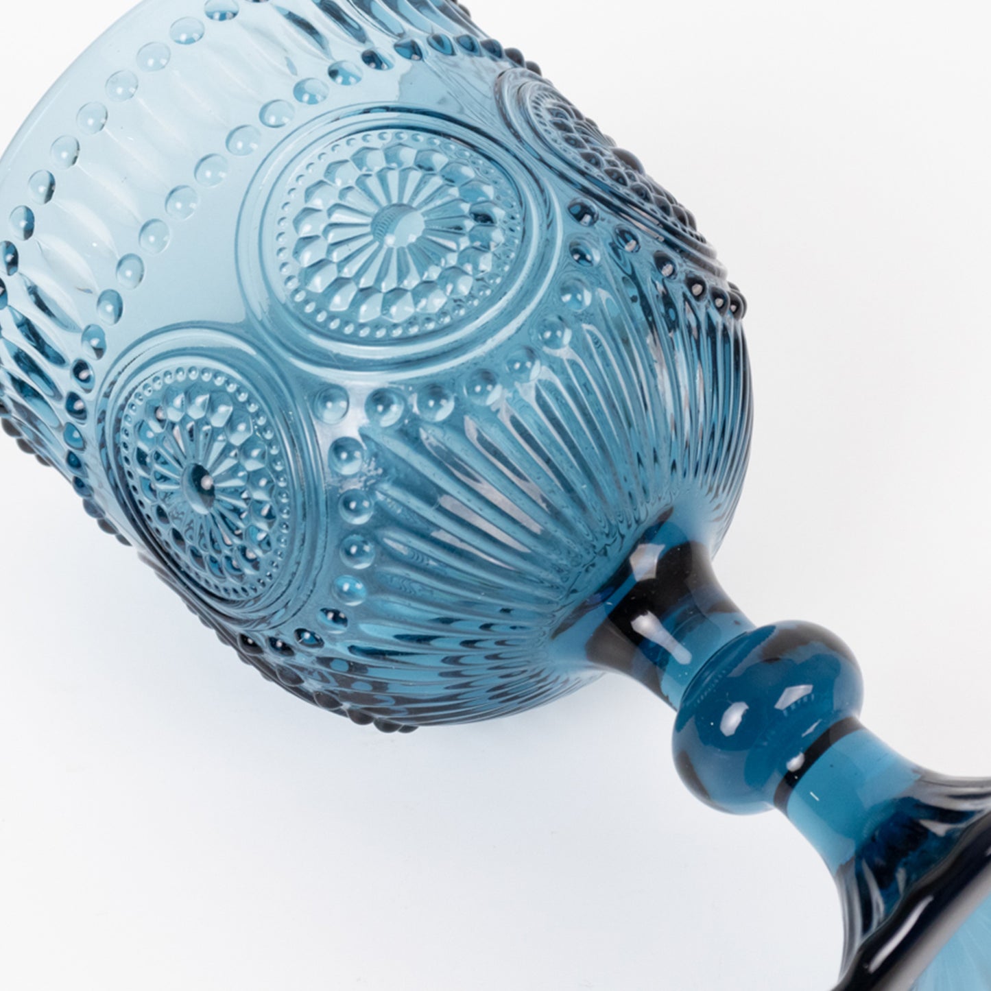 Ocean blue vintage embossed goblet wine glass with textured floral pattern.