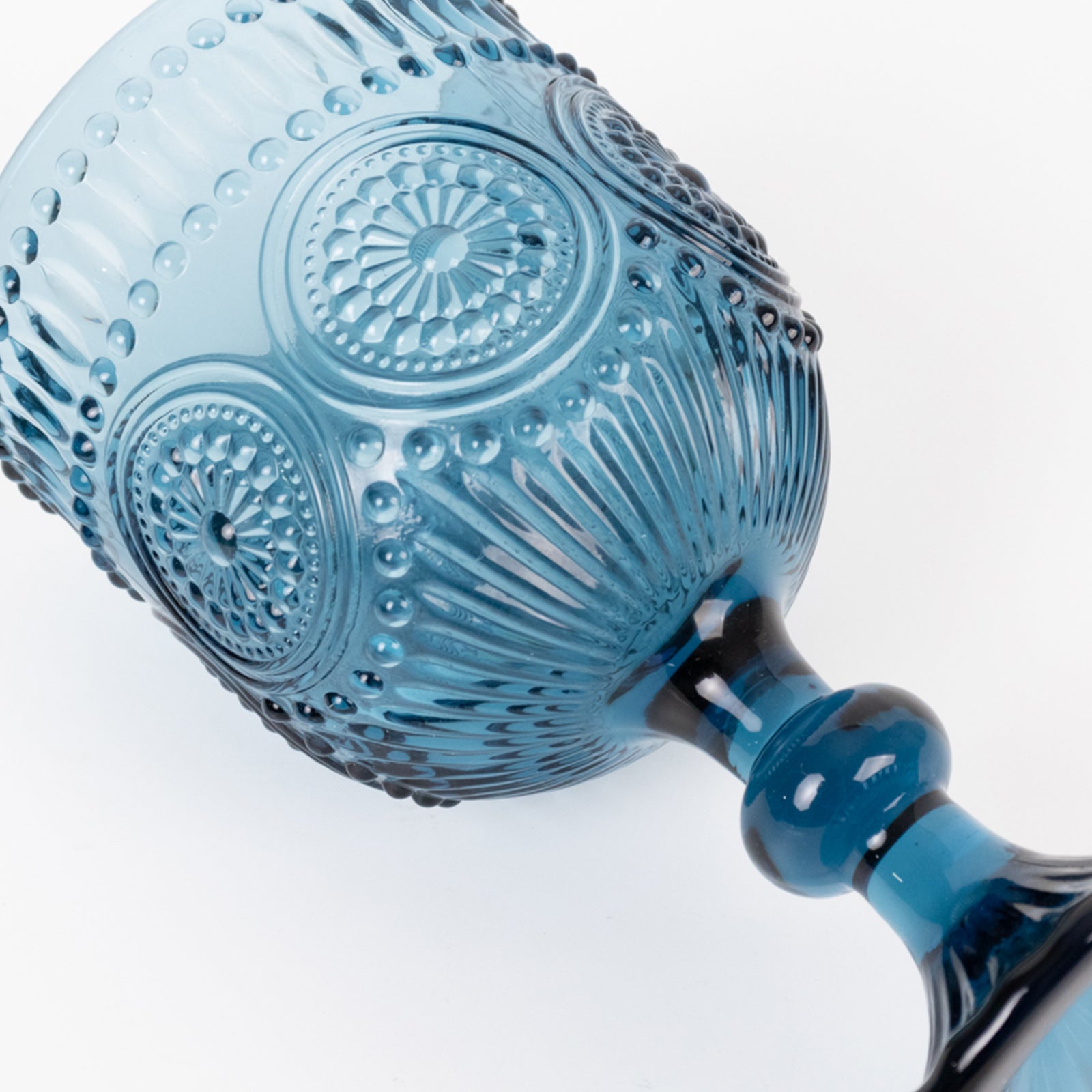 Ocean blue vintage embossed goblet wine glass with textured floral pattern.