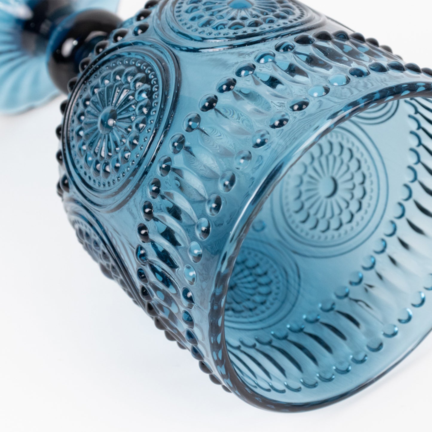Ocean blue vintage embossed goblet wine glass with floral pattern.