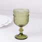 Dusty sage green vintage embossed goblet wine glass with floral pattern.