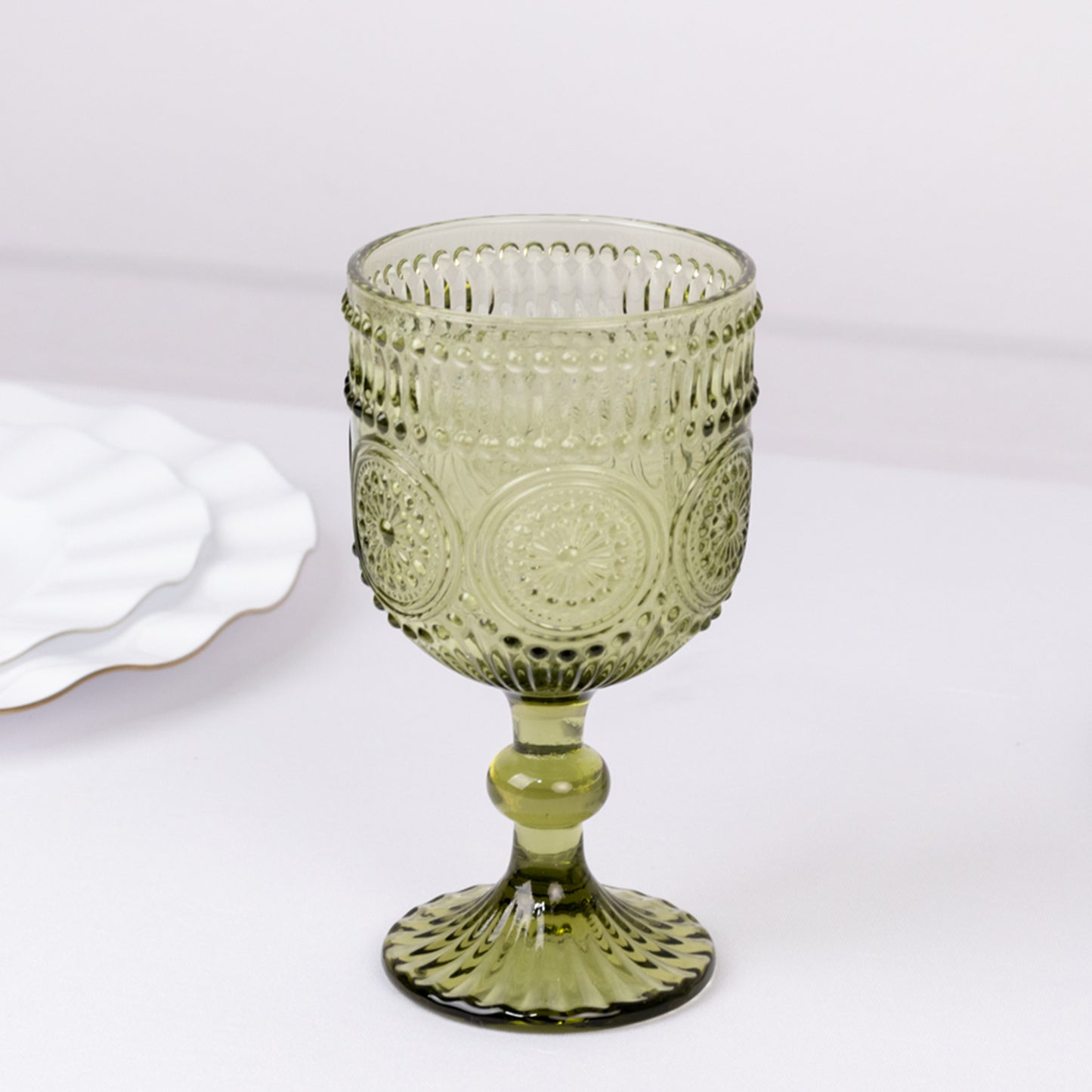 Dusty sage green vintage embossed goblet wine glass with floral pattern.