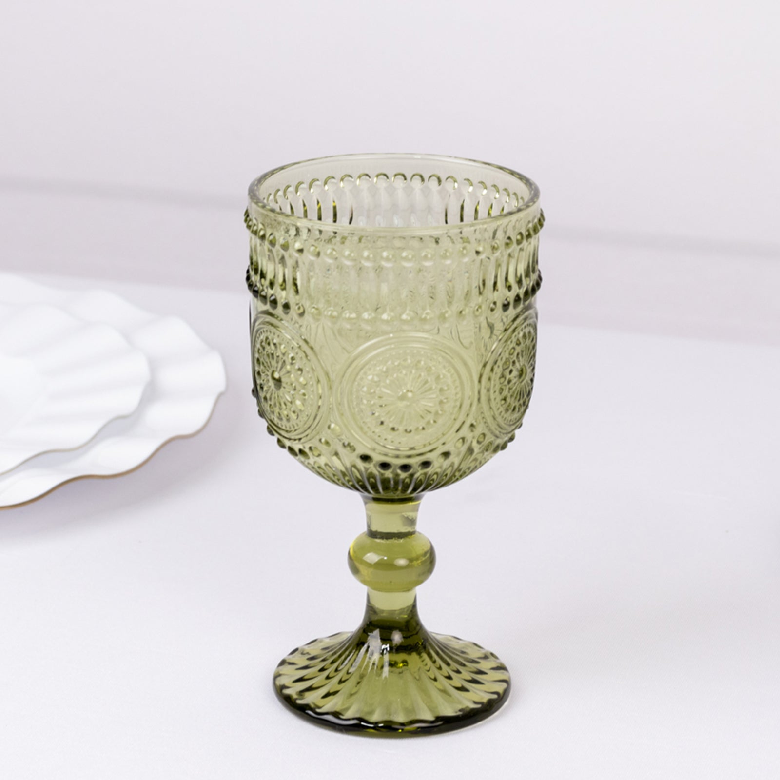 Dusty sage green vintage embossed goblet wine glass with floral pattern.