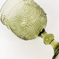 Dusty sage green vintage embossed goblet wine glass with floral pattern.