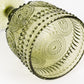 Dusty sage green vintage embossed goblet wine glass with floral pattern.