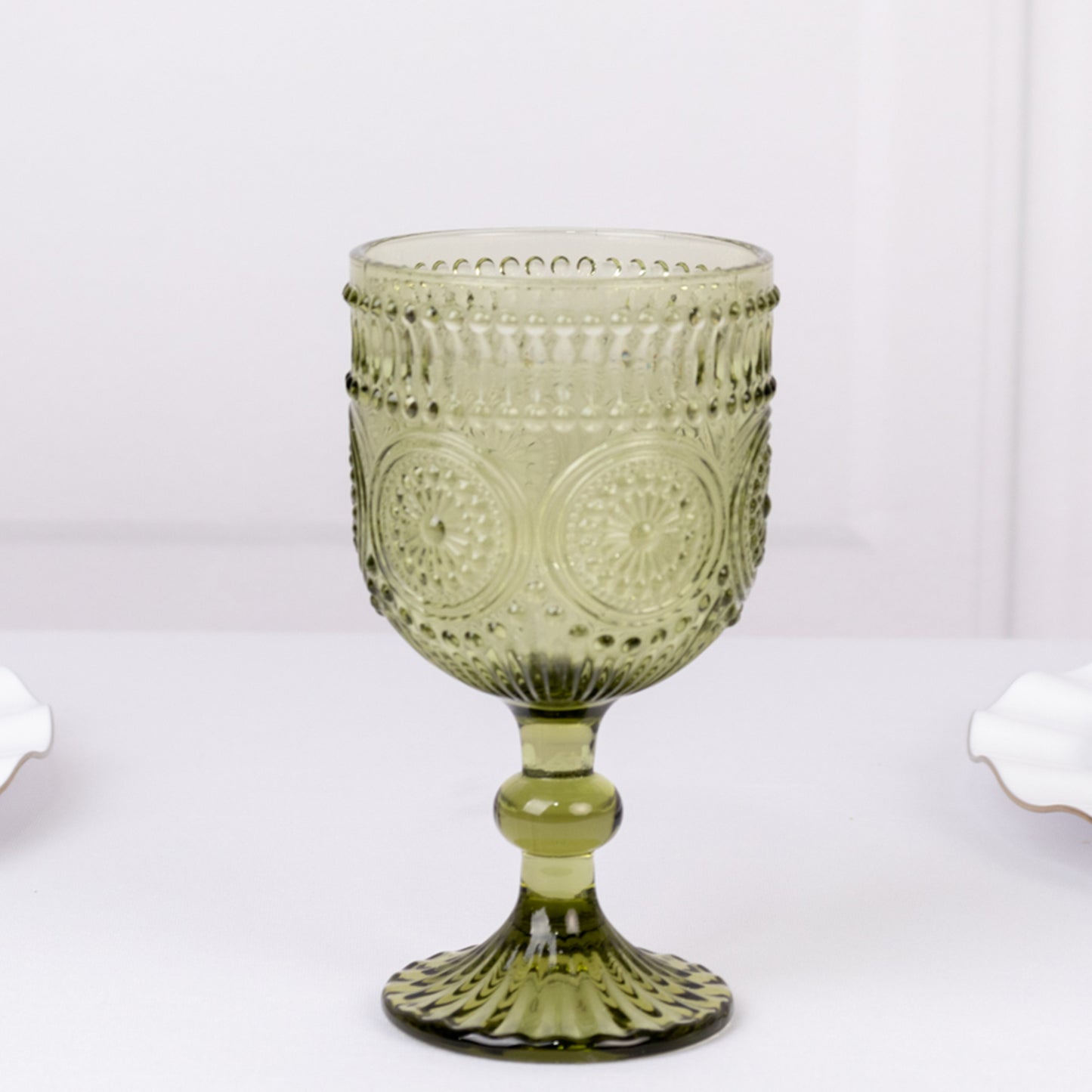 Dusty sage green vintage embossed goblet wine glass with floral pattern.