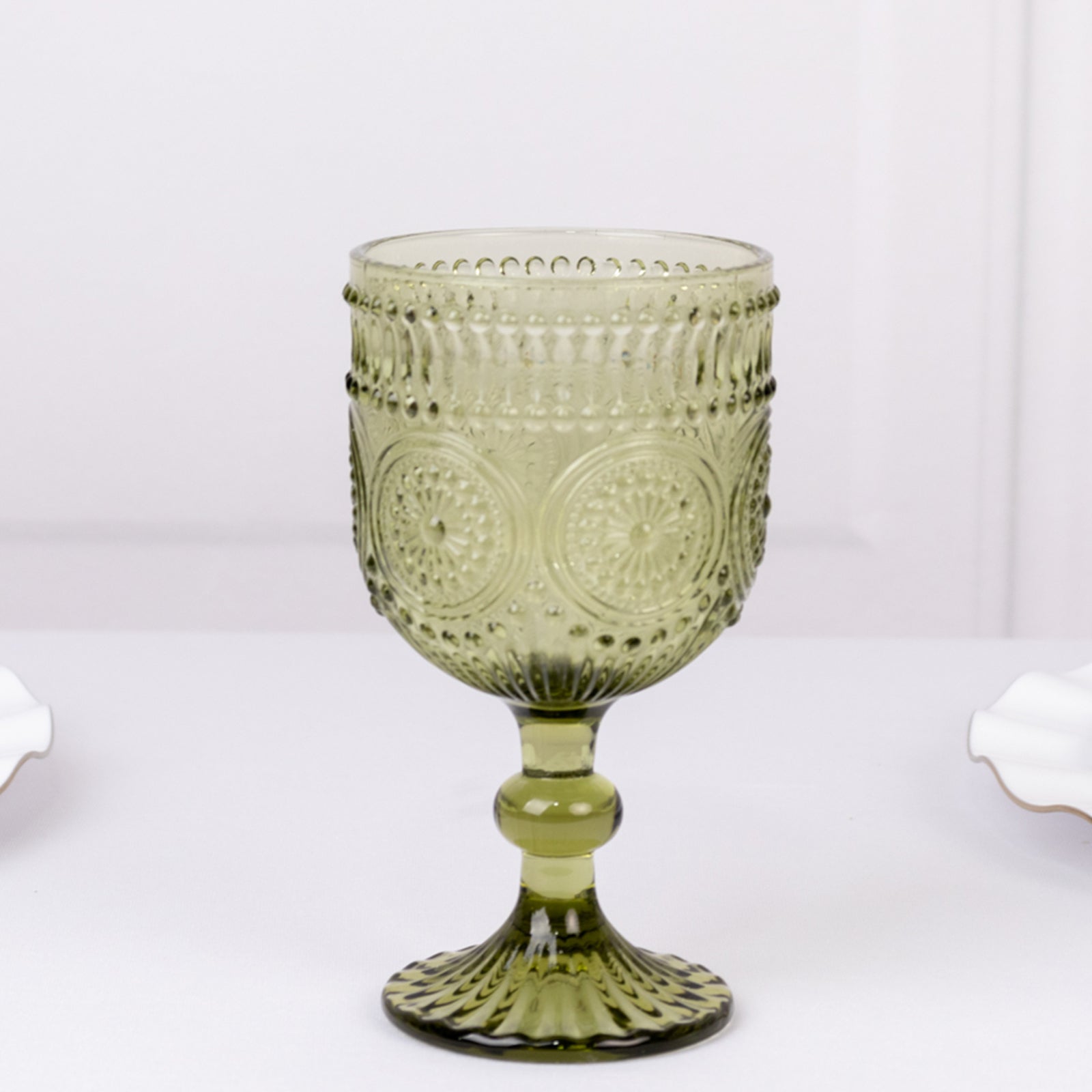 Dusty sage green vintage embossed goblet wine glass with floral pattern.
