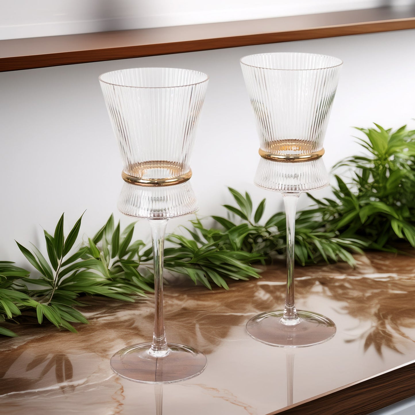 Clear wine glasses with ribbed design and gold ring accent.