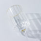 Clear glass vintage wine goblet with gold rim, ribbed design.