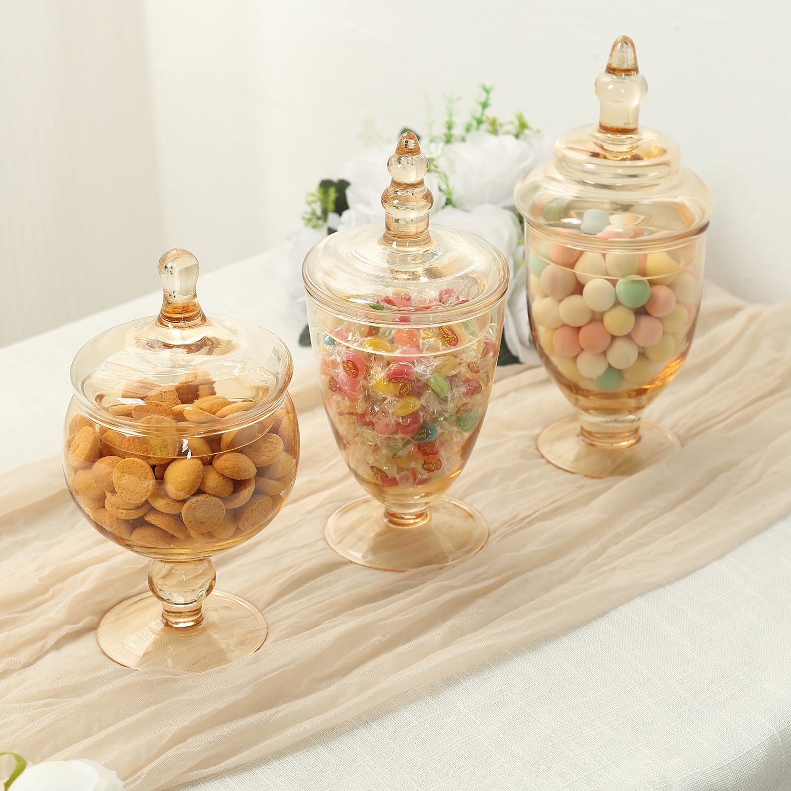 Amber gold decorative glass jars with snap-on lids for storage.