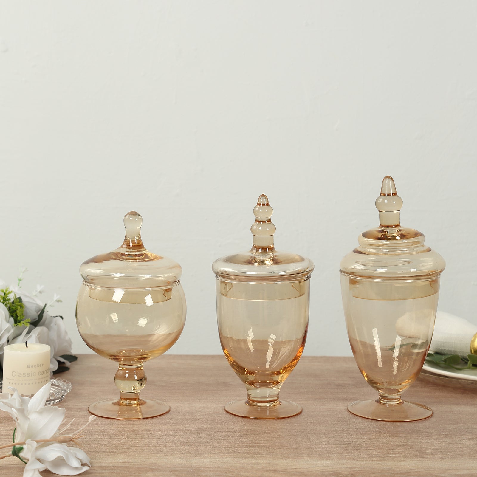 Amber gold apothecary jars with snap-on lids, decorative footed candy containers.
