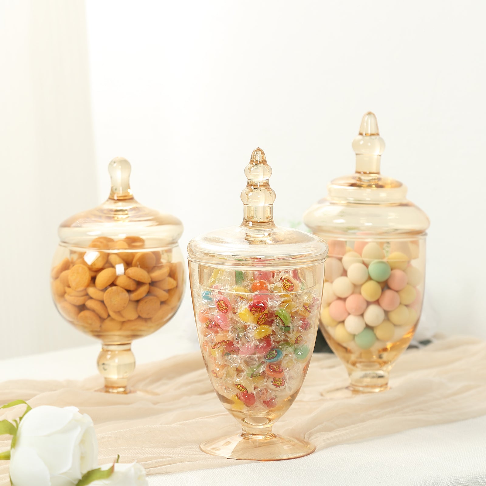 Amber gold apothecary glass jars with snap-on lids, decorative footed storage.