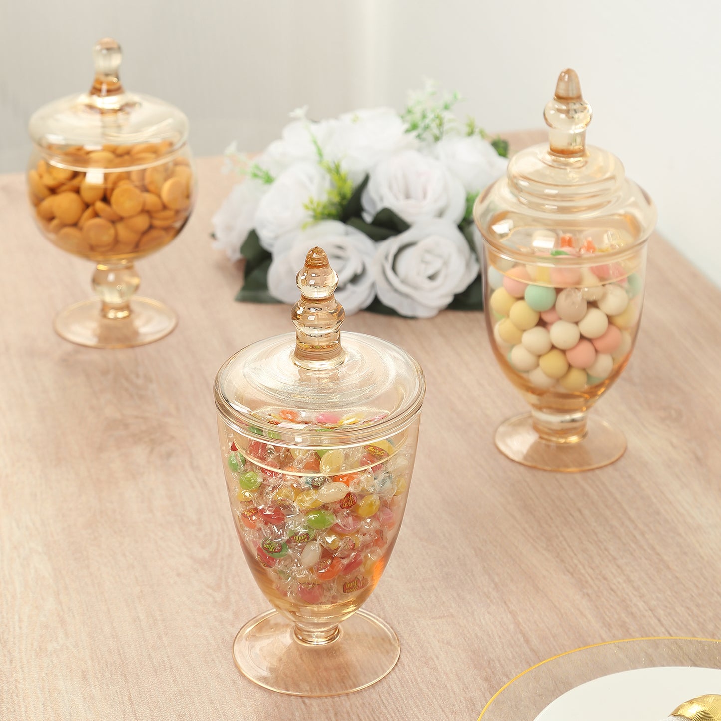 Amber gold decorative apothecary jars with lids for candy storage.