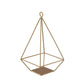 Gold metal pyramid tealight candle holder, open frame geometric design.