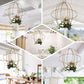 Gold open frame centerpiece ball candle holder with floral display.