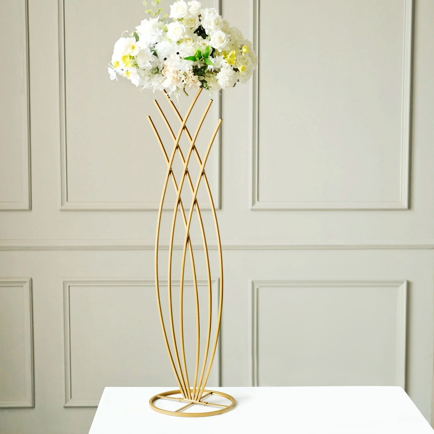 Gold metal mermaid tail flower frame centerpiece with floral display.