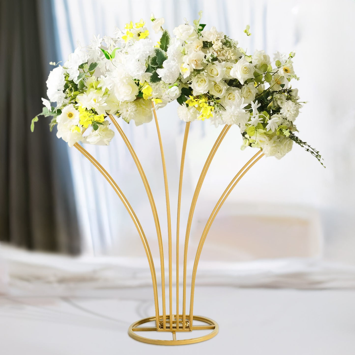 Gold metal scalloped fan-shaped flower frame centerpiece with white floral display.