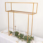 Gold metal floral arrangement tabletop display rack on a table.