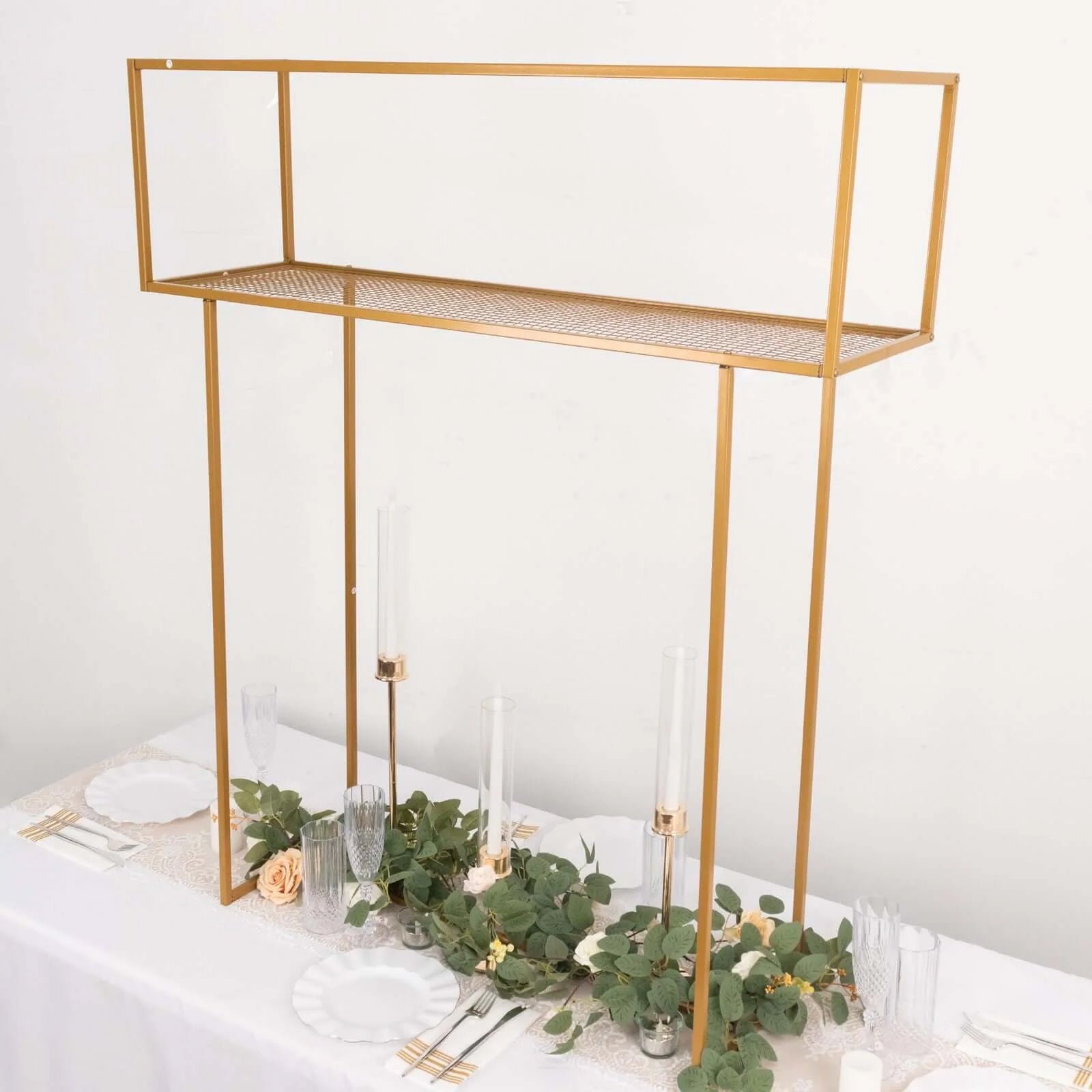 Gold metal floral arrangement tabletop display rack on a table.