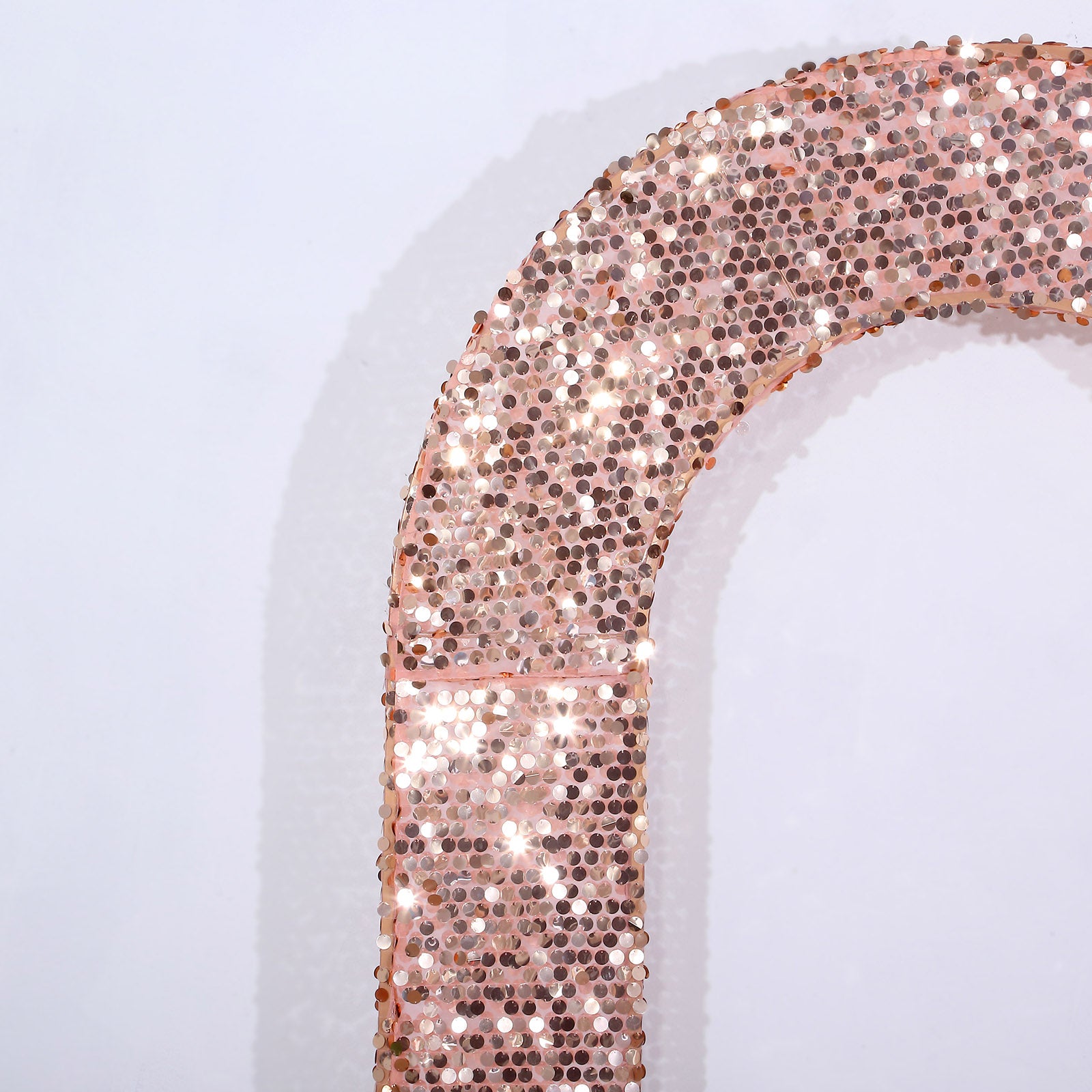 Rose gold sequin wedding arch cover with a U-shaped design.