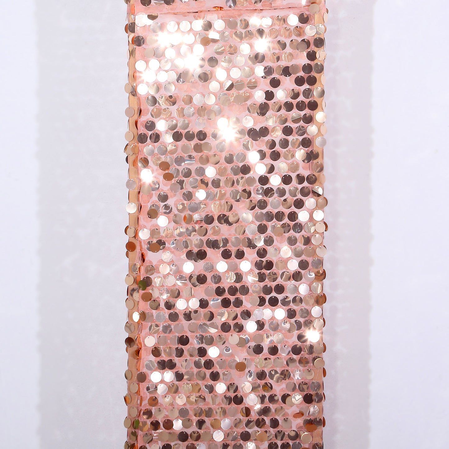 Rose gold sequin wedding arch cover with a shimmering finish.