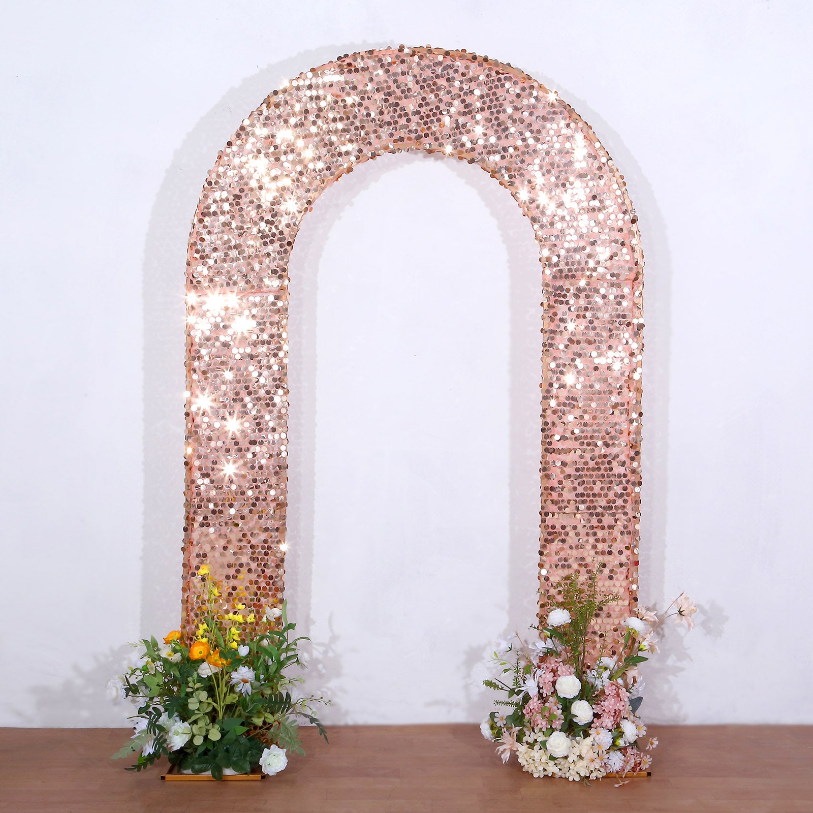 8ft rose gold sequin wedding arch backdrop with floral arrangements.