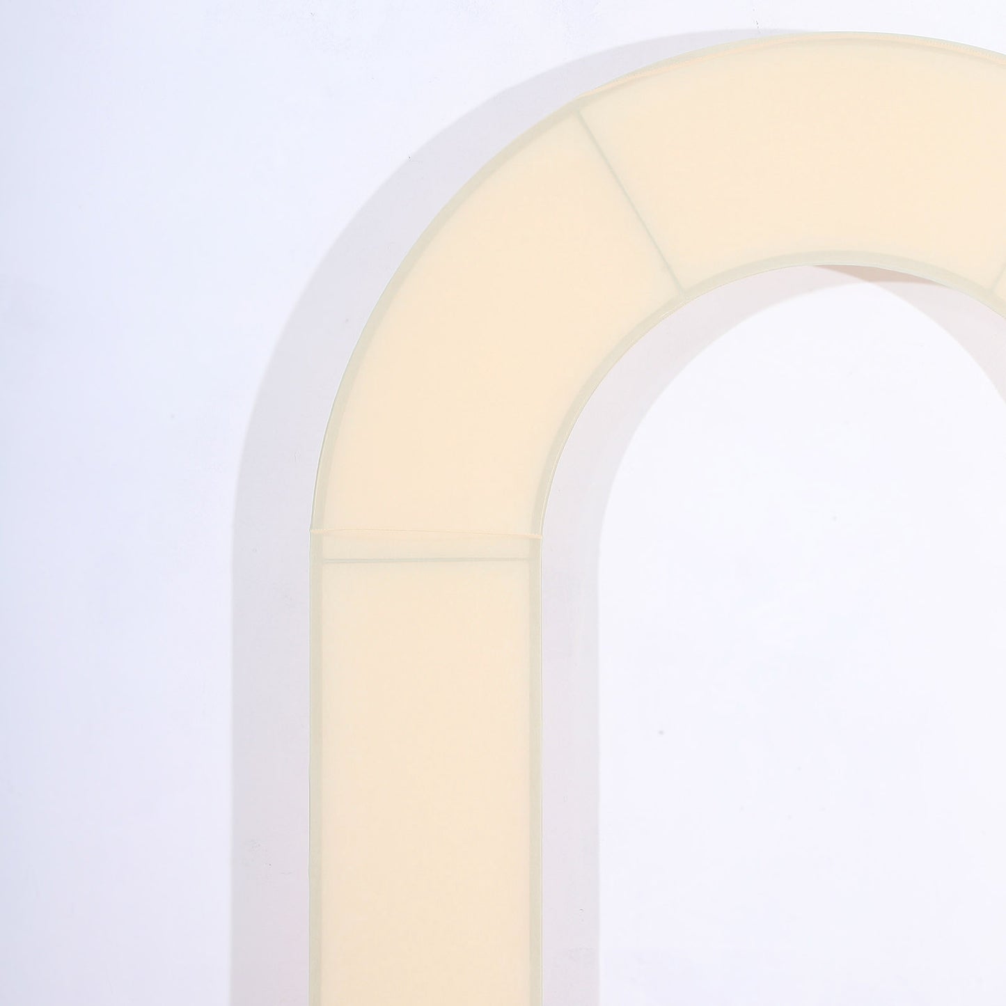 Beige spandex fitted wedding arch cover with U-shaped design.