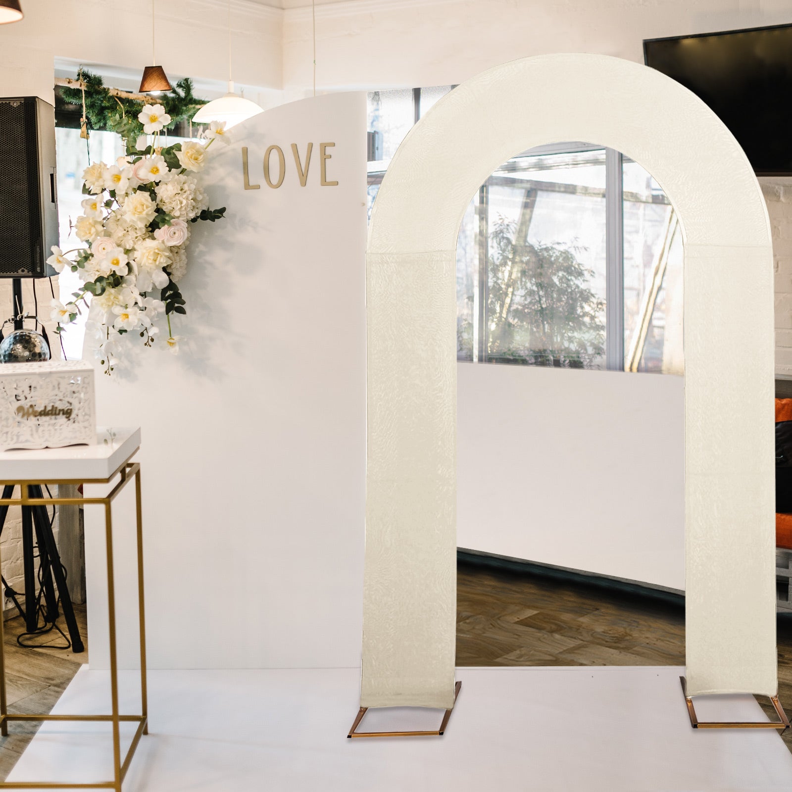 Beige spandex fitted wedding arch cover in a stylish event setting.