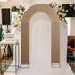 Taupe spandex fitted wedding arch cover with floral backdrop.