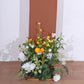 8ft terracotta spandex wedding arch cover with floral arrangement at the base.