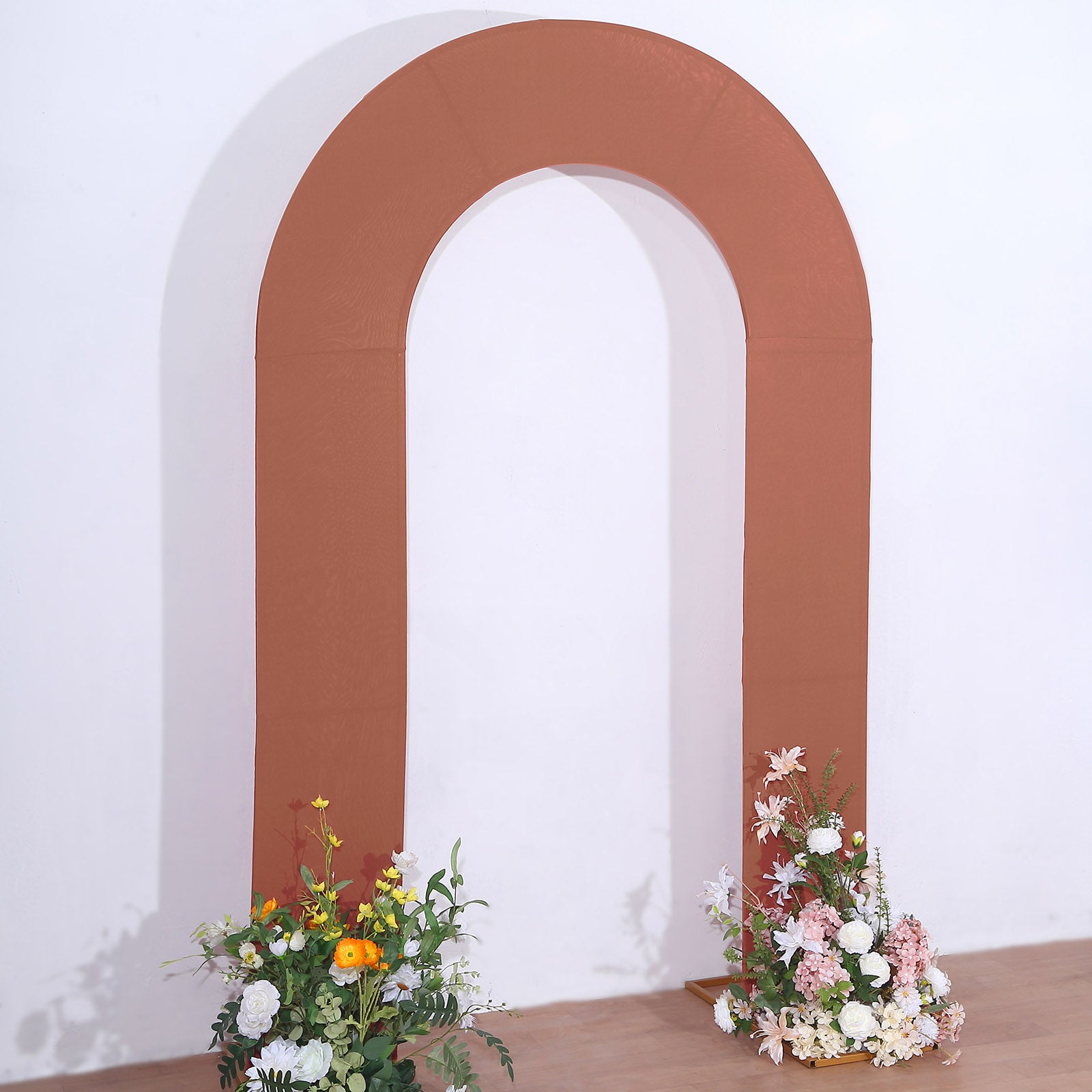 8ft rust spandex fitted wedding arch cover with floral arrangements.