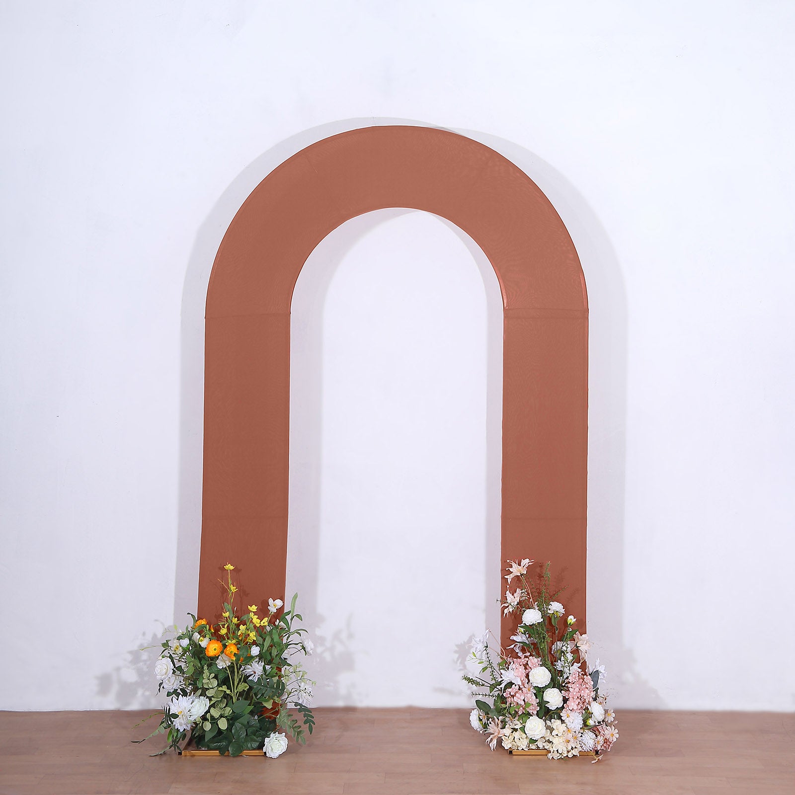 8ft rust spandex wedding arch cover with floral arrangements.