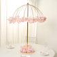 Gold floral umbrella stand with pink flowers, perfect for wedding centerpieces.