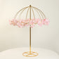 Gold metal umbrella flower stand with pink floral accents.