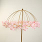 Gold metal umbrella flower stand with pink floral accents.