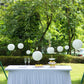 Set of 8 ivory hanging paper lanterns in assorted sizes.