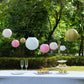 Set of 8 blush gold hanging paper lanterns in assorted sizes.