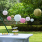 Set of 8 mixed blush gold hanging paper lanterns in assorted sizes.
