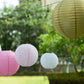 Mixed blush gold hanging paper lanterns in assorted sizes.