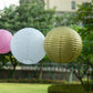 Mixed blush and gold hanging paper lanterns in assorted sizes.