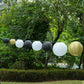 Mixed black and gold paper lanterns in assorted sizes.