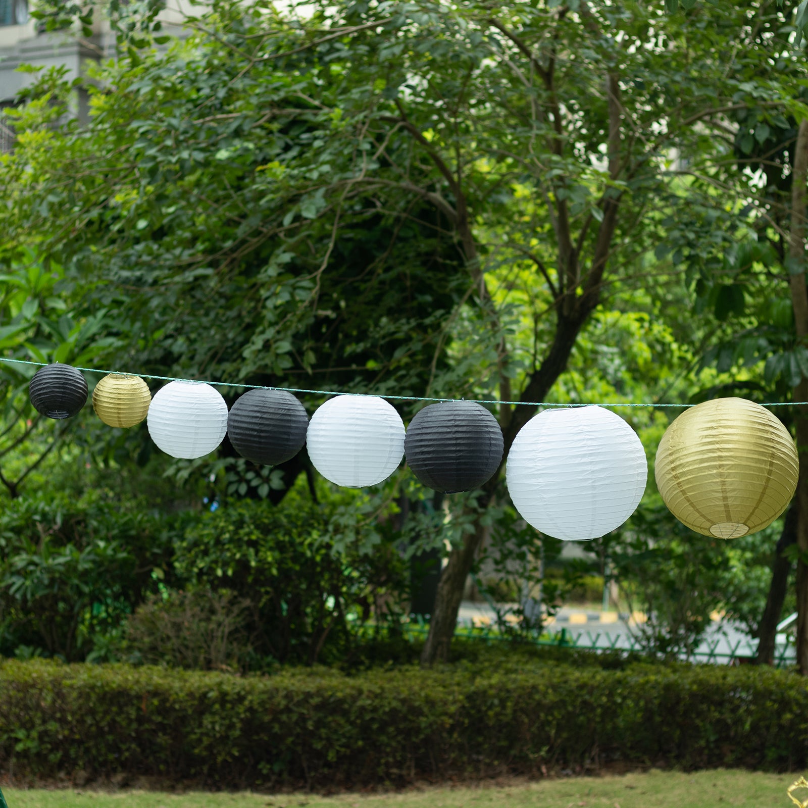 Mixed black and gold paper lanterns in assorted sizes.