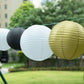 Set of 8 black and gold hanging paper lanterns in assorted sizes.