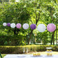 Mixed purple and white hanging paper lanterns for decorative occasions.