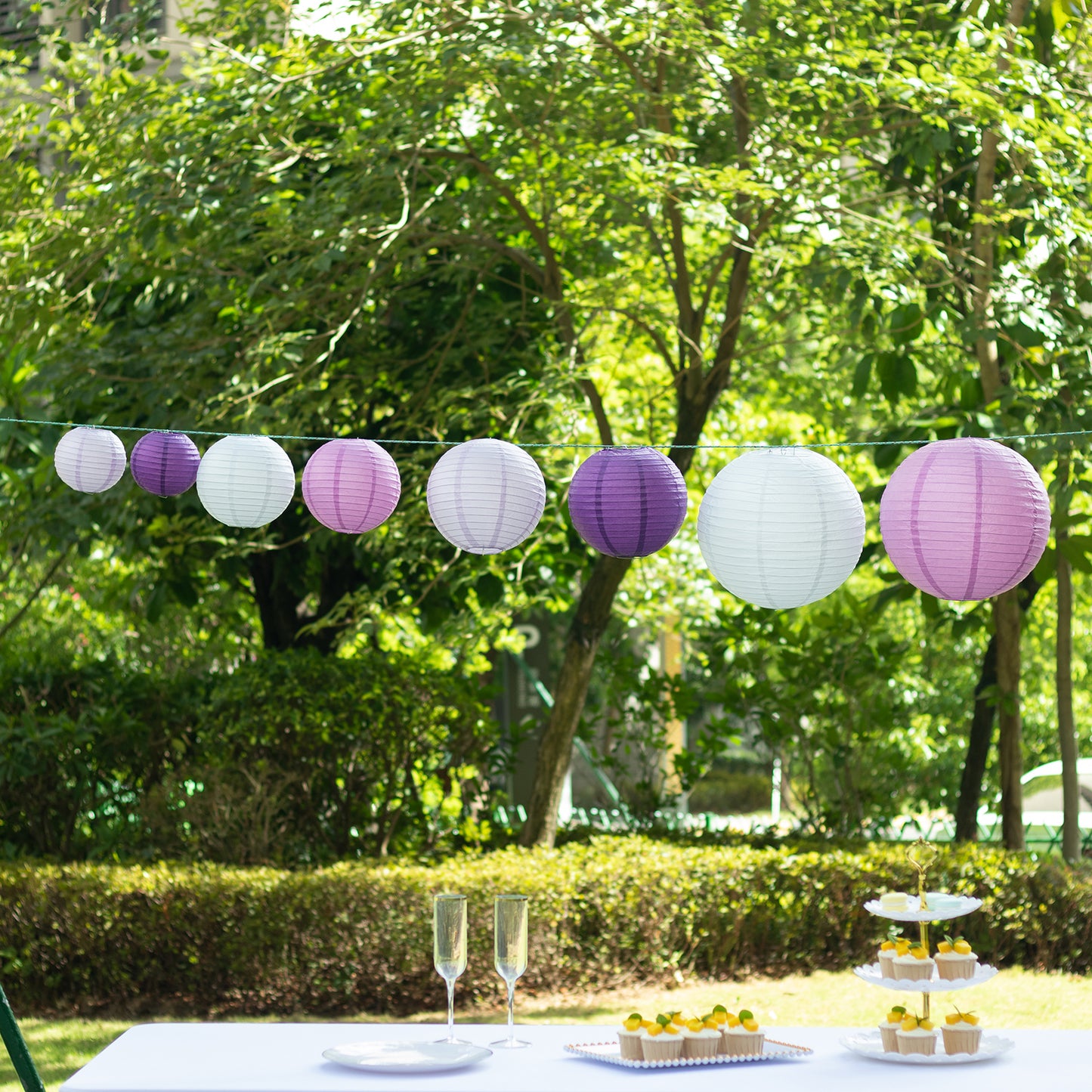 Mixed purple and white hanging paper lanterns for decorative occasions.