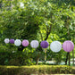 Set of 8 mixed purple and white hanging paper lanterns in various sizes.