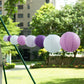 Mixed purple and white hanging paper lanterns in various sizes.